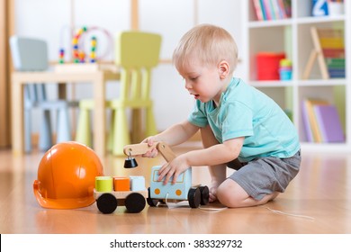 Child Boy Toddler Playing With Toy Car Indoors