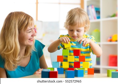 Child Boy Together With Mother Playing Educational Toys