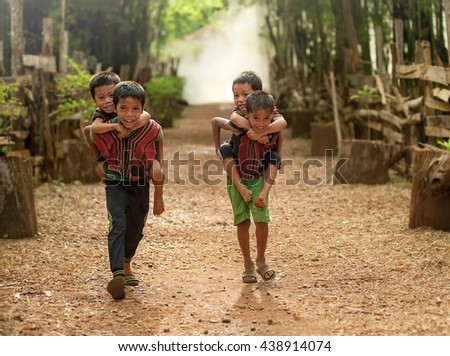 Child boy tribal playing ride back merrily