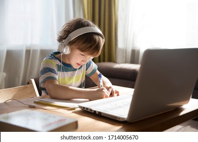 Child Boy Is Using A Laptop And Study Online At Home. Homeschooling, Distant Learning