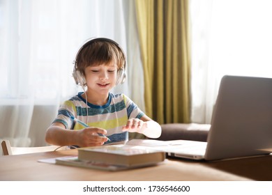 Child Boy Is Using A Laptop And Study Online At Home. Homeschooling, Distant Learning