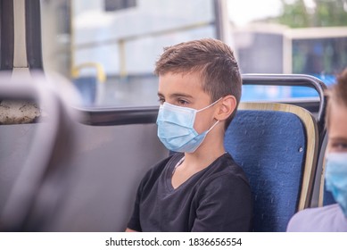 Child boy wearing medical protective mask in public transport bus. covid-19