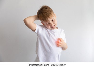 Child Boy In White T-shirt Isolated On White Background Scratching His Body. Scabies, Skin Disease Rash. 