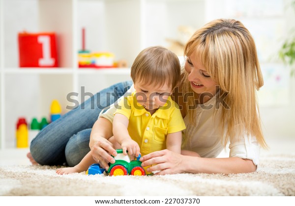 child boy and woman\
play with toy indoor