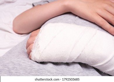 A Child Broken Arm In Plaster Case, Hand Injury Because Of Accident, Forearm Bones Fracture.