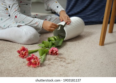 Child And Broken Ceramic Vase On Floor At Home, Closeup