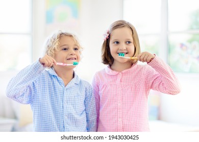 Child Brushing Teeth. Kids With Toothpaste And Brush. Dental And Oral Hygiene, Care. Healthy Daily Routine For Children. Kid After Shower Or Bath At Home. Girl And Boy In Pajamas With Tooth Paste.