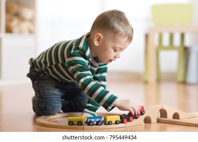 Child Building And Playing Toy Railroad At Home Or Daycare. Kid Boy Play With Train And Cars.