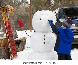 Child Building A Snowman