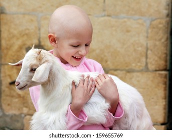 A Child With Cancer Carrying A Goat 