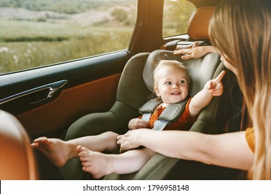 Child In Car Baby Sitting In Safety Seat Mother Fasten Belt Family Lifestyle Travel Vacation With Kid 