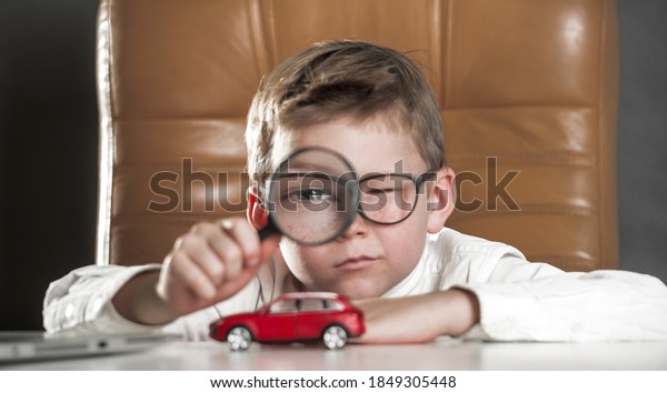 Child car expert. Kid with big\
magnifying glass observing a toy car. Businessman choose a\
car