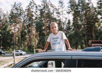 Child In The Car Roof Hatch Outside