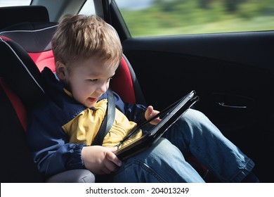 Child In The Car With Tablet PC