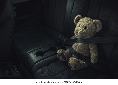 Child Car Transportation Safety Theme. Teddy Bear On A Backseat With Fasten Seat Belt.