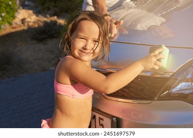 Child, car wash and portrait with helping for fun in summer for development with learning, smile and family. Cleaning, water and happy with soap on weekend with relax for bonding with relationship - Powered by Shutterstock