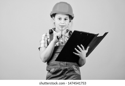 Child care development. Foreman inspector. Repair. Safety expert. Future profession. small girl repairing in workshop. Builder engineer architect. Kid worker in hard hat. examining. - Powered by Shutterstock - Get 15% off with code: PIKWIZARD15