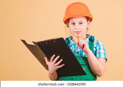 Child care development. Foreman inspector. Repair. Safety expert. Future profession. small girl repairing in workshop. Builder engineer architect. Kid worker in hard hat. examining. - Powered by Shutterstock