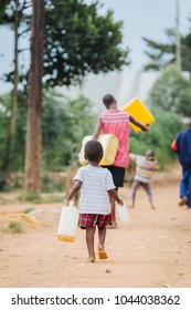 Child Carrying Water Can In Uganda Africa