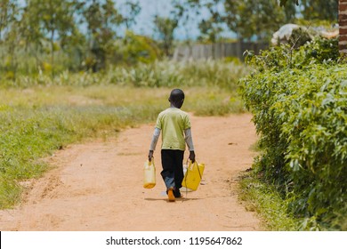 Child Carrying Water In Uganda, Africa