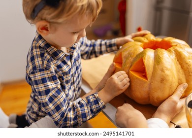 Child carving pumpkin for Halloween - Powered by Shutterstock