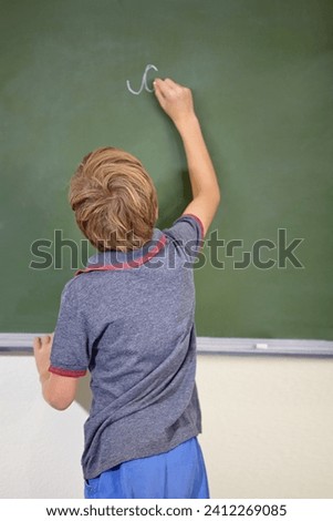 Child, chalkboard and school writing with education, cursive and answer for learning. Back, knowledge and kid development in a study lesson with student in a classroom with chalk and solution