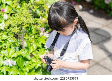 A child checking a photo taken with a camera