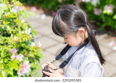 A child checking a photo taken with a camera