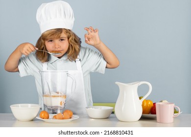 Child Chef Cook Prepares Food On Isolated Grey Studio Background. Kids Cooking. Teen Boy With Apron And Chef Hat Preparing A Healthy Vegetables Meal In The Kitchen.