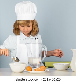 Child Chef Cook Prepares Food On Isolated Grey Studio Background. Kids Cooking. Teen Boy With Apron And Chef Hat Preparing A Healthy Vegetables Meal In The Kitchen.