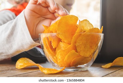 child with chips behind a computer. selective focus. nature.