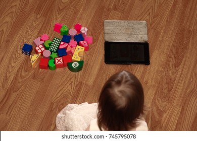 The child chooses a gadget instead of developing toys and exercises. The choice of a modern child. The concept.