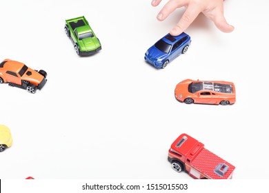 Child Chooses His Favourite Toy Car From Selection Of Toys