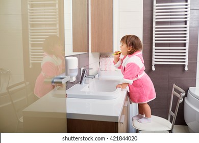 Child Cleaning Teeth In Bathroom.