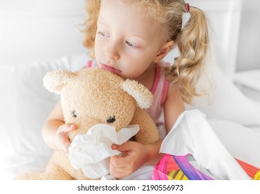 The Child Cleans The Nose Of The Bear. Play During Illness.