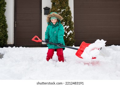 Child Clearing Sidewalks And Shoveling Snow. Girl Removaling Snow With  Shovel. Little Helper For Parents. Winter Kids Fun Outdoor Sports