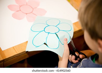 The Child Cleaves Flower Of Colored Paper.