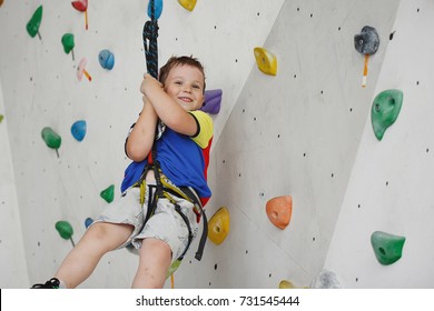 Child climbing on a high wall