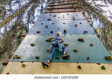 The child climbs up the climbing wall - Powered by Shutterstock