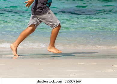 Child Closeup Legs Only Runs On The Beach Barefoot.