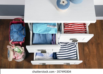 Child Clothes In Wooden Chest Of Drawer, Close Up