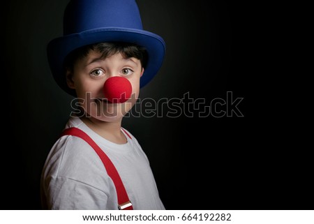 Similar – funny child with clown nose on blue background