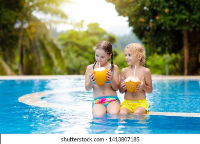 Child With Coconut Drink In Outdoor Swimming Pool. Kids Swim In Tropical Resort. Healthy Exotic Fruit Refreshment For Children. Travel With Young Kid. Beach And Water Fun. Summer Family Vacation.