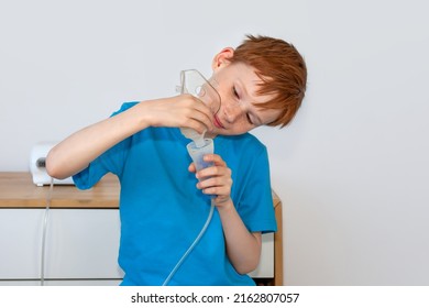 The Child Collects A Nebulizer For Inhalation. The Concept Of Cough Treatment, Covid19.