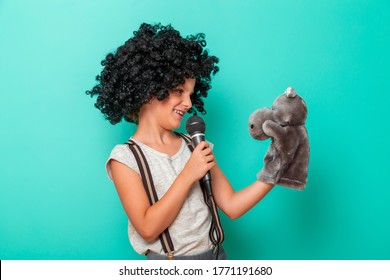 Child Comedian Performing With A Puppet, Isolated On Mint Colored Background