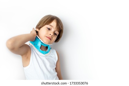 Child Complaining Of Neck Pain Wearing A Cervical Collar Support. White Background