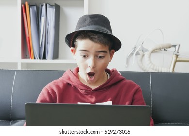 Child With The Computer Laptop With Face Of Astonishment And Surprise