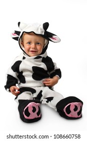 The Child In A Costume Of A Cow On A White Background