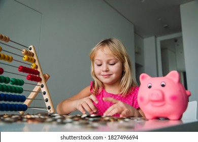 Child Counting Money, Girl Put Coins Into Piggy Bank