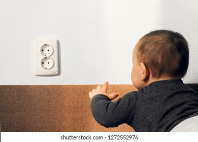 Child Crawl Put Fingers Electric Socket Wall Outlet Hazard Danger Safety Home Concept